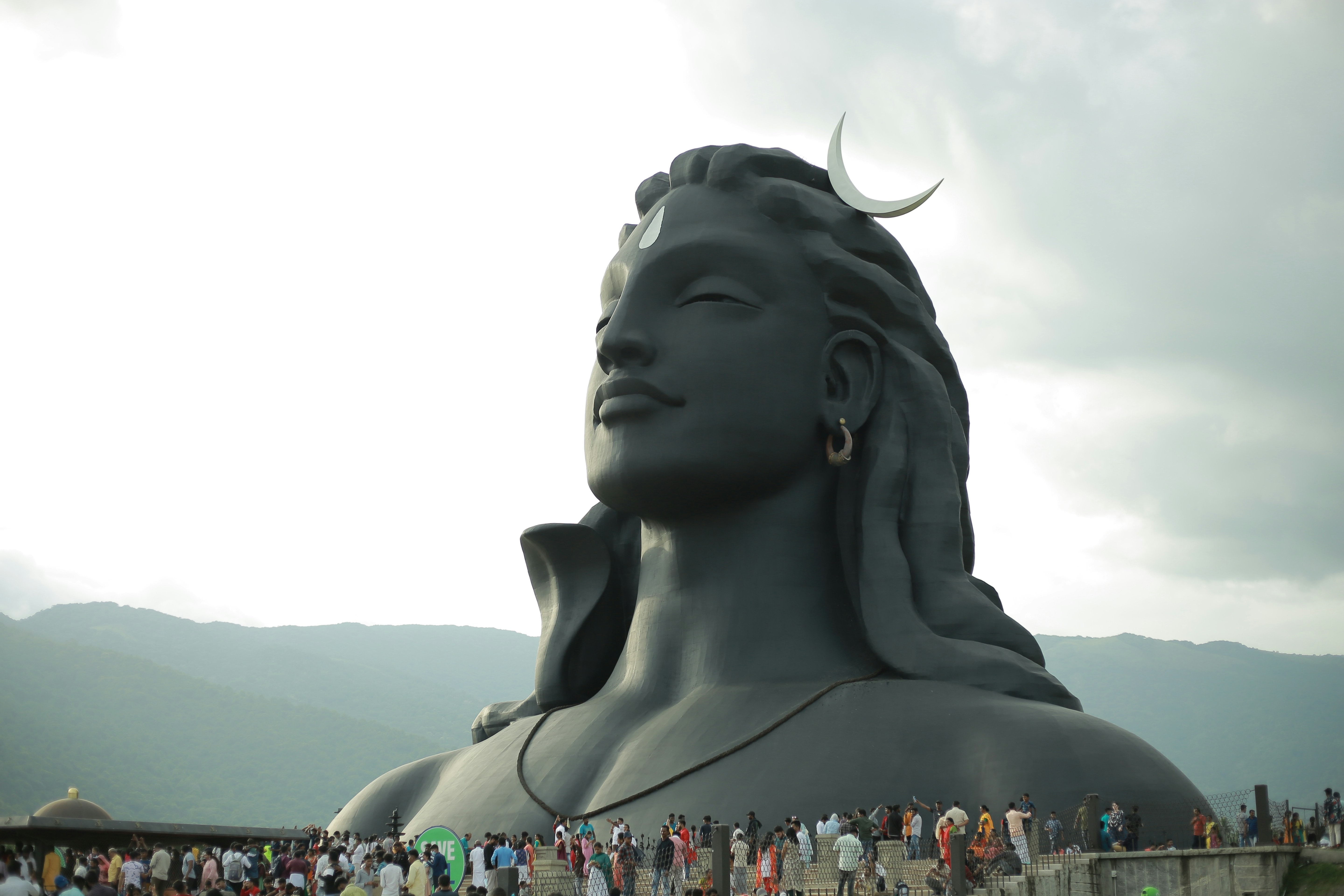 a large statue of a person with horns and a crowd of people