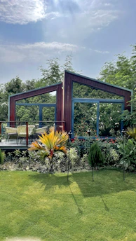 A sleek modular gazebo set up in a lush backyard with soft lighting.