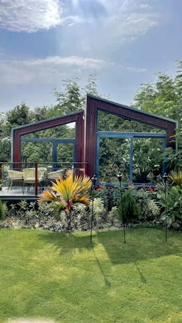 An outdoor seating area surrounded by lush greenery, perfect for relaxing after gardening.