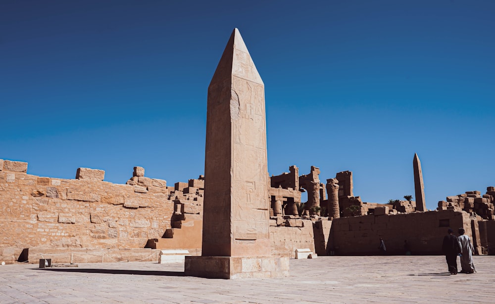 a group of people standing in front of a stone structure