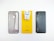 A phone case, phone charger, and a smartphone are placed side by side on a white surface. The phone case is translucent with cutouts for the camera and fingerprint sensor. The charger is white and attached to a bright yellow card that has small text and the brand logo. The smartphone is black with a triple camera setup, fingerprint sensor, and brand logo on the back.