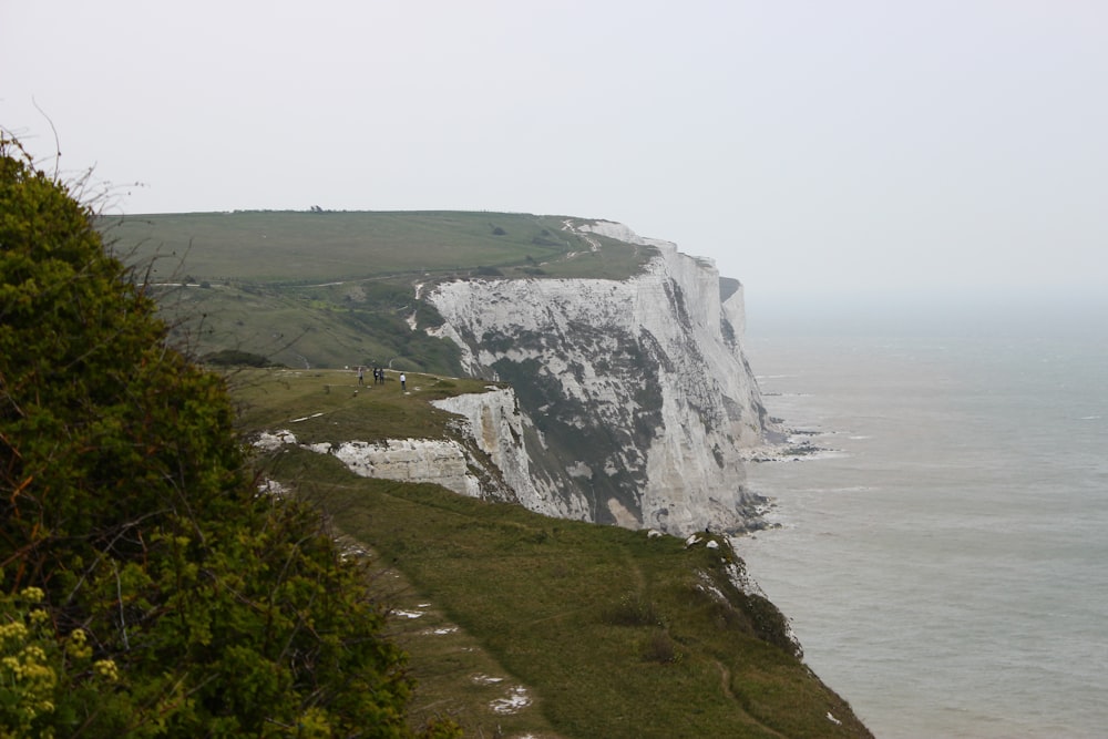 a cliff with a body of water below