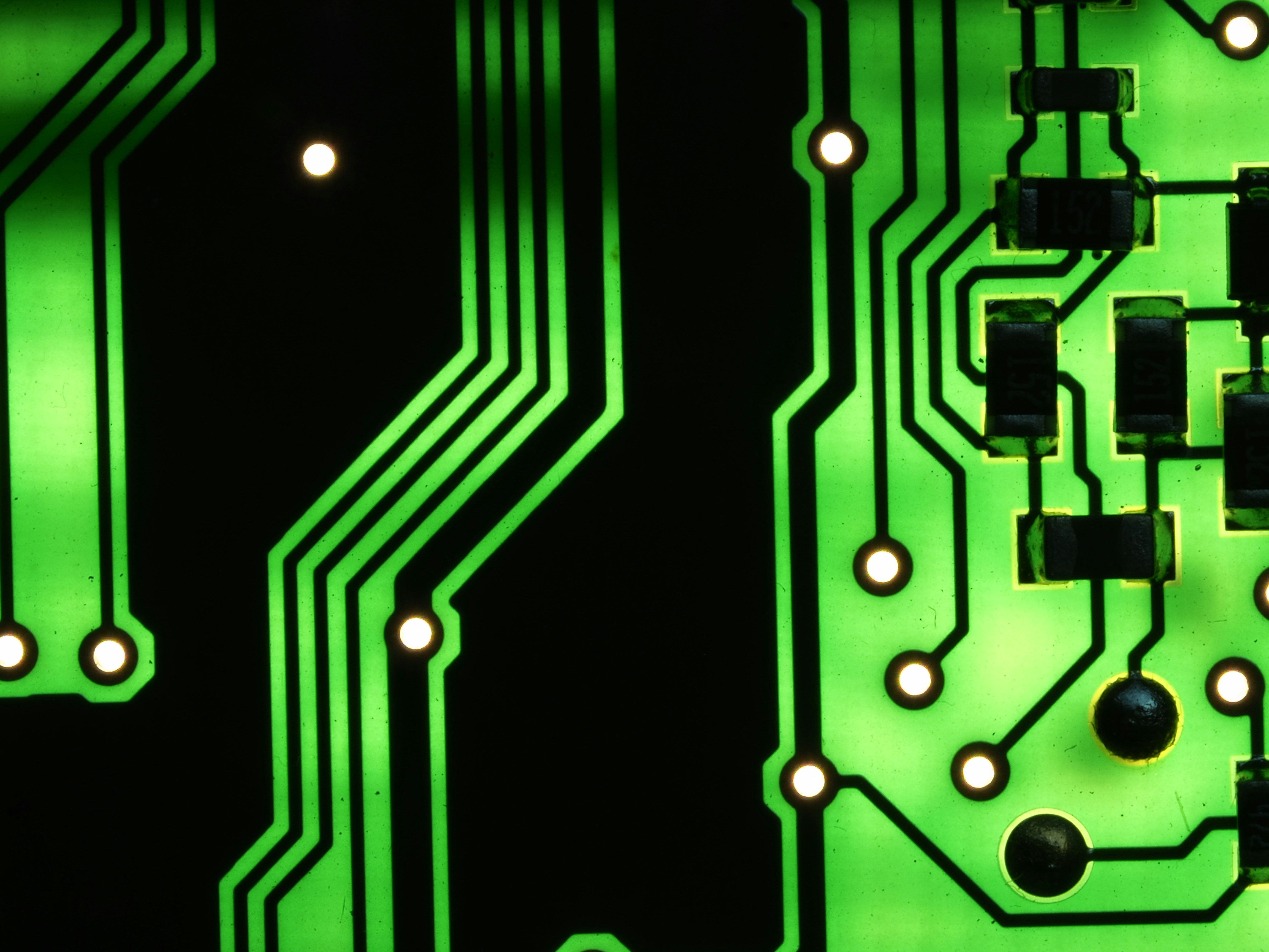 Glowing circuit board macro photography with blue and green light trails, technology concept