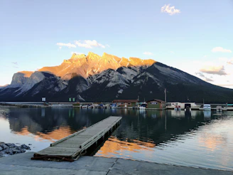 a dock leading to a mountain