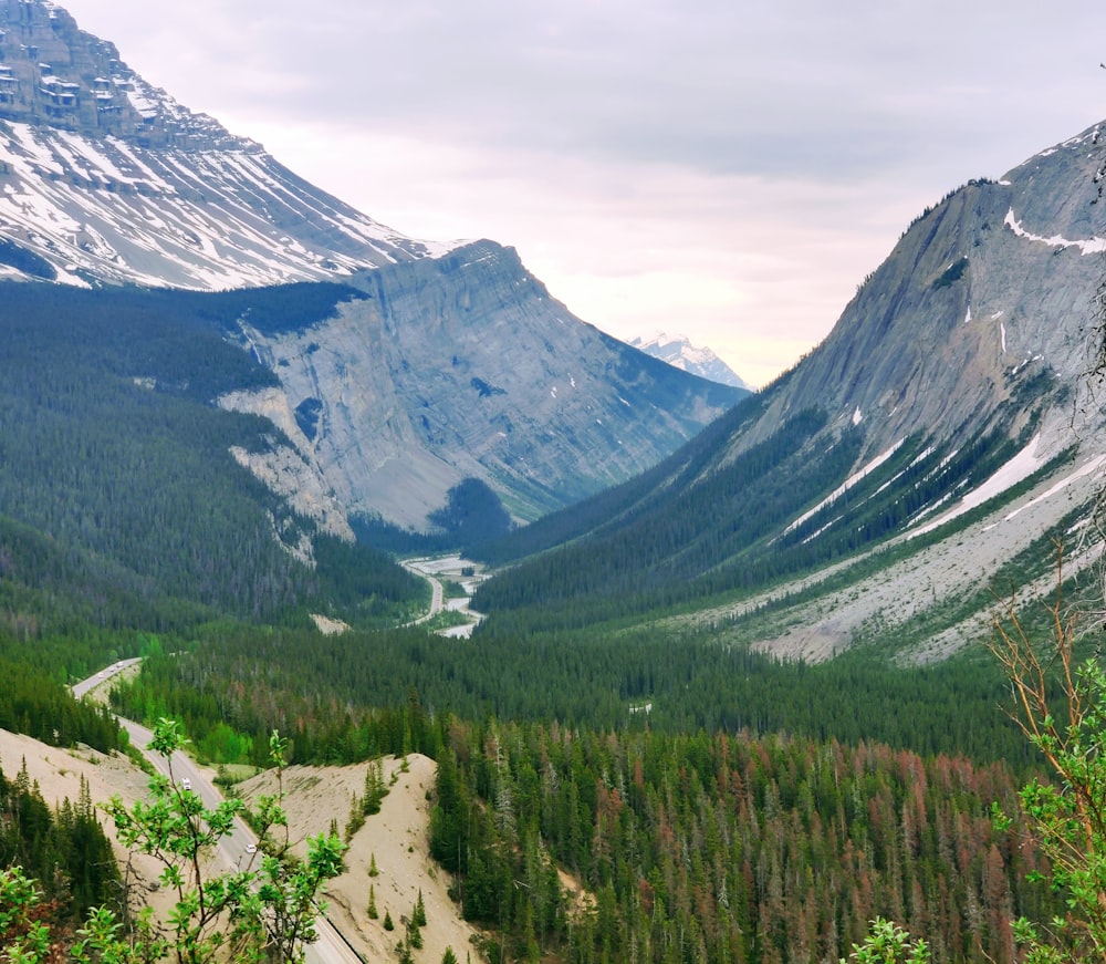 a river running through a valley between mountains