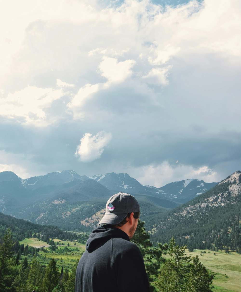 a man looking at a mountain range