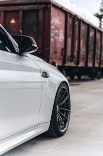 A close-up of a car being loaded onto a flatbed truck.