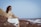 a person sitting on a rock