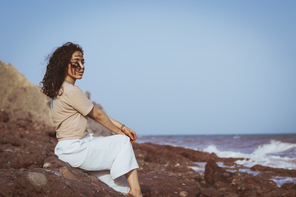 a person sitting on a rock