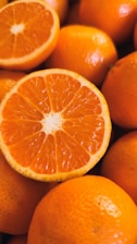 Close-up of fresh orange slices with juice droplets glistening in natural light.