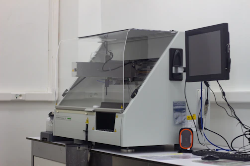 A friendly technician carefully preparing a DNA sample in a clean, modern lab setting.