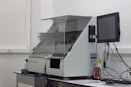A professional technician calibrating a Haier Biomedical vaccine refrigerator in a clean pharmaceutical environment.