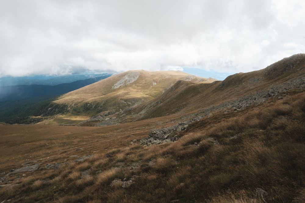 a grassy hill with a valley below