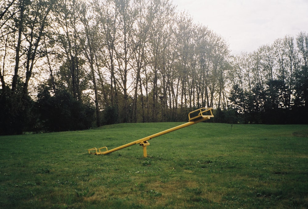 a yellow object in a grassy area