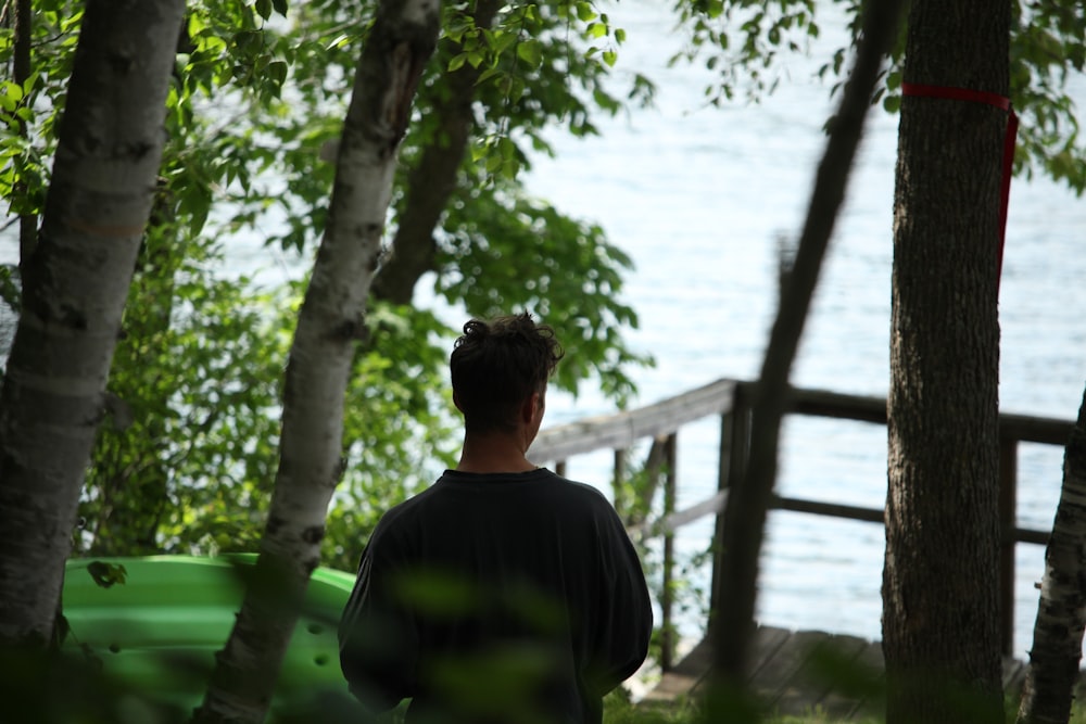 a man standing in front of a lake