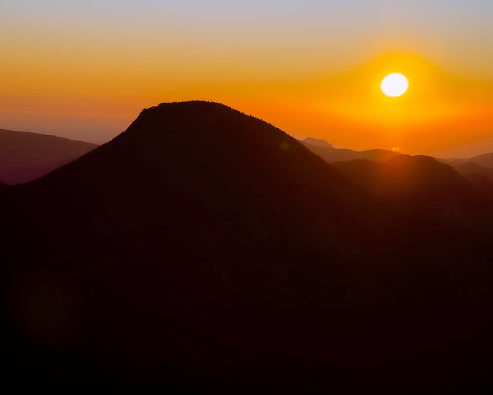 a sunset over a mountain