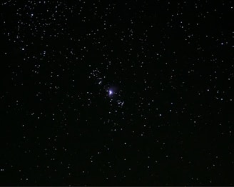 a starry night sky with a bright light in the middle with Gallery Arcturus in the background