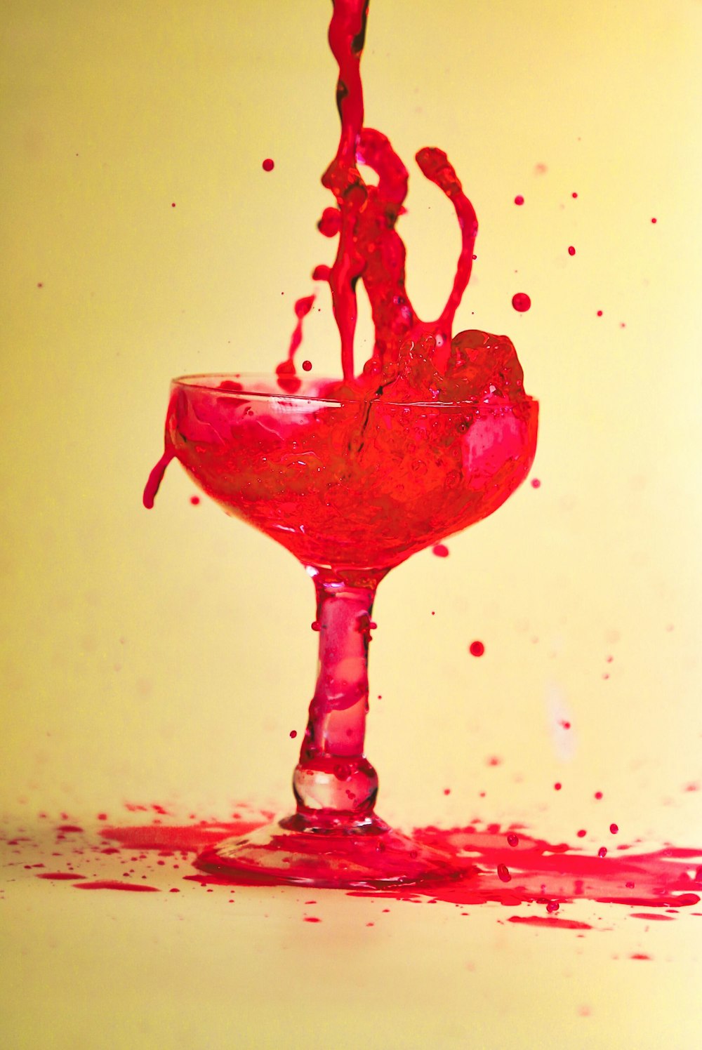 a red liquid splashing into a glass
