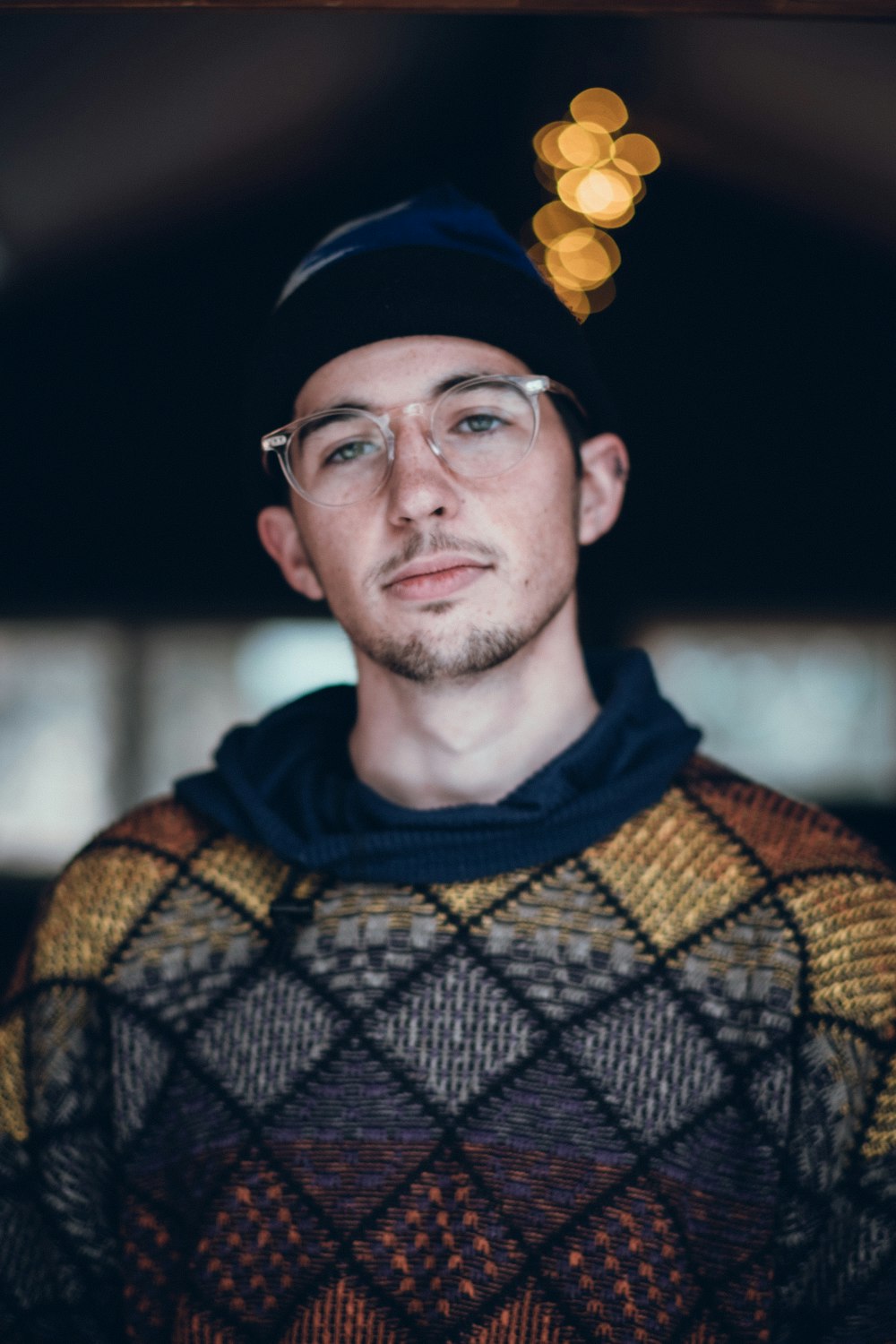 a man wearing glasses and a hat