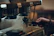A focused man practicing espresso machine skills during a barista demo class.