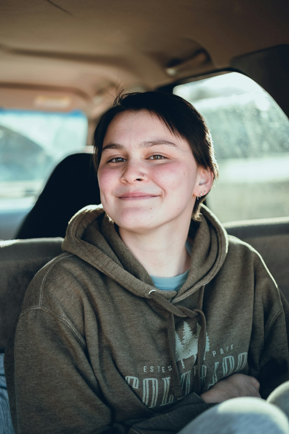 a boy sitting in a car