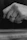 Artistic shot of a man admiring a sleek, contemporary ring against a minimalist background.