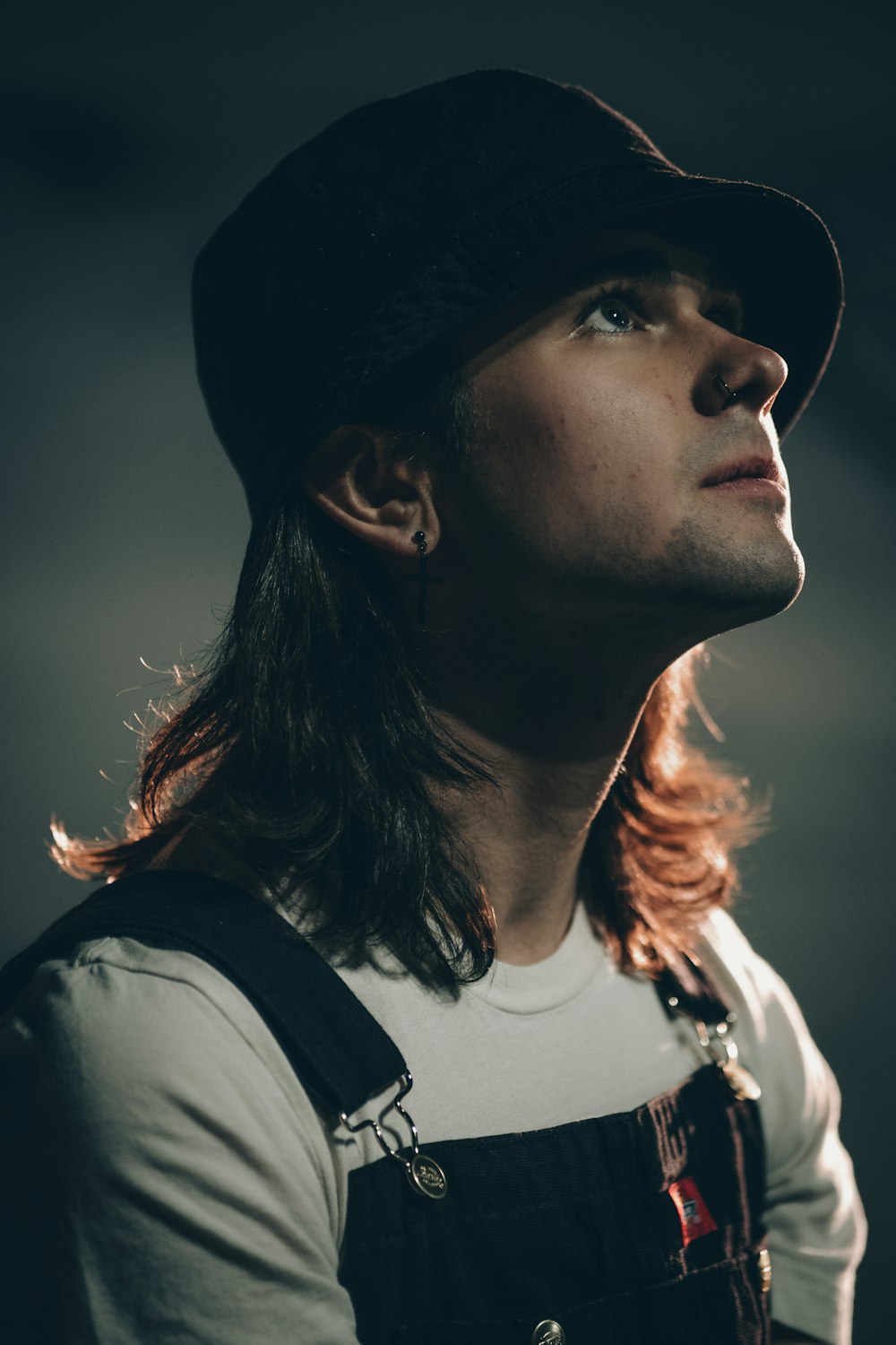 a person with long hair and a hat