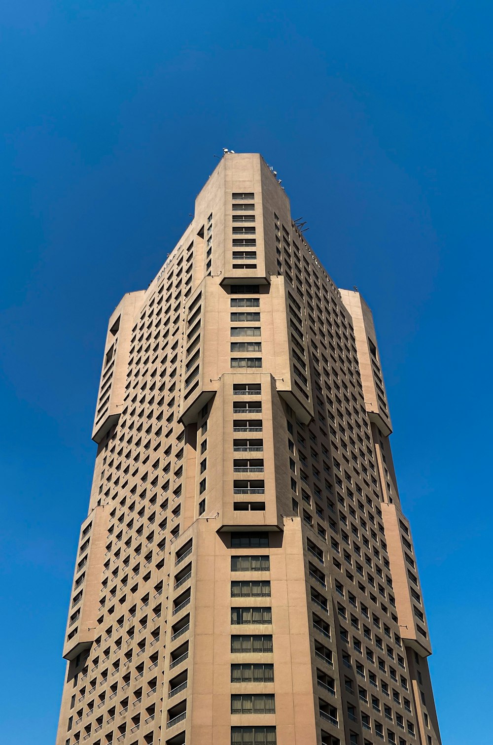 a tall building with a blue sky