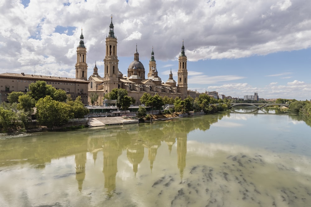 a large building with towers and a bridge over a body of water