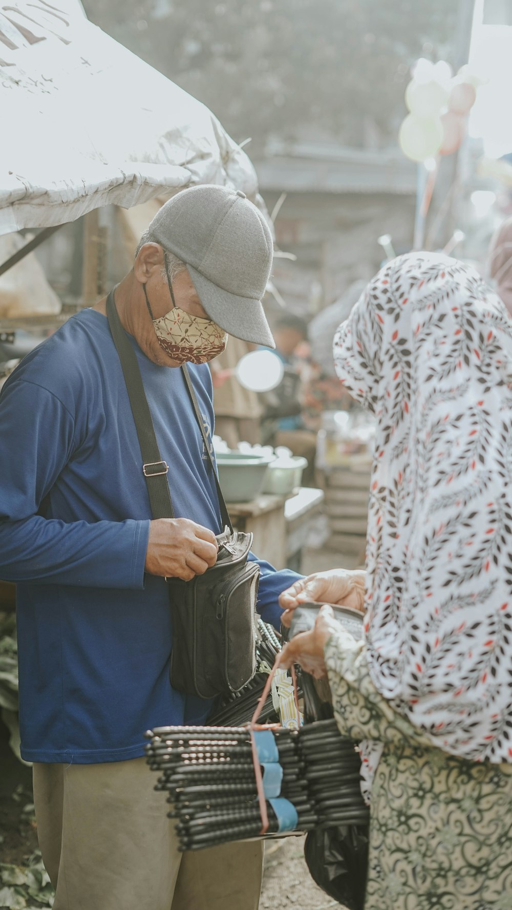 a man holding a bag and a woman holding a bag