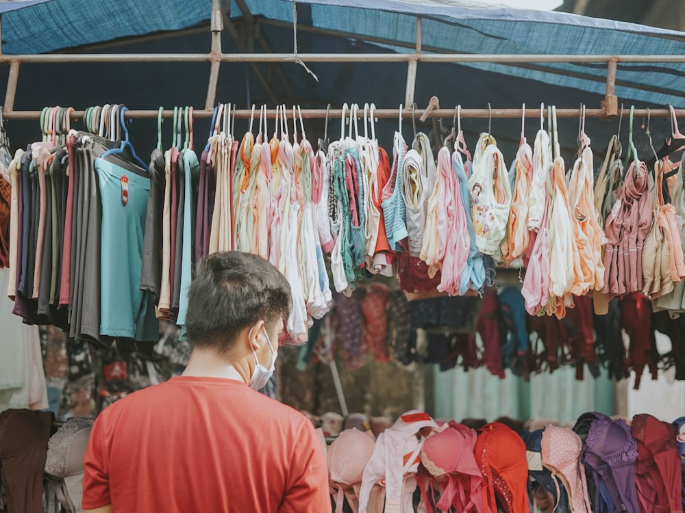 a person looking at a rack of clothes