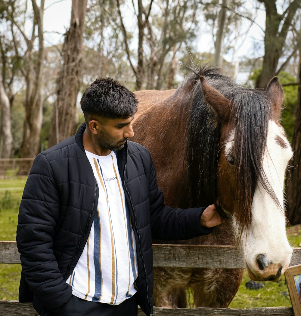 a person touching a horse