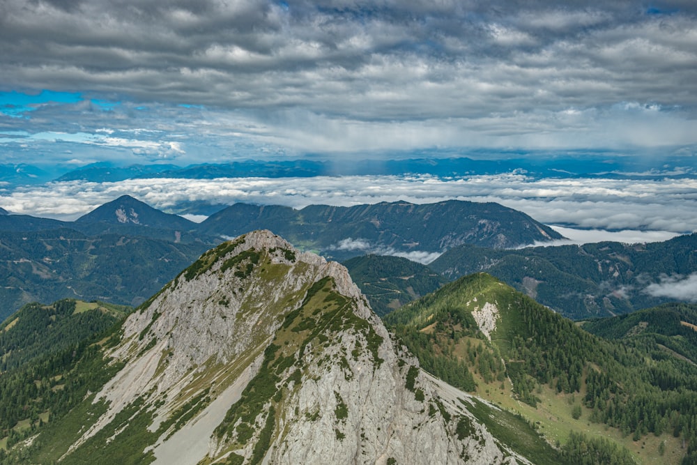 a mountain with clouds above