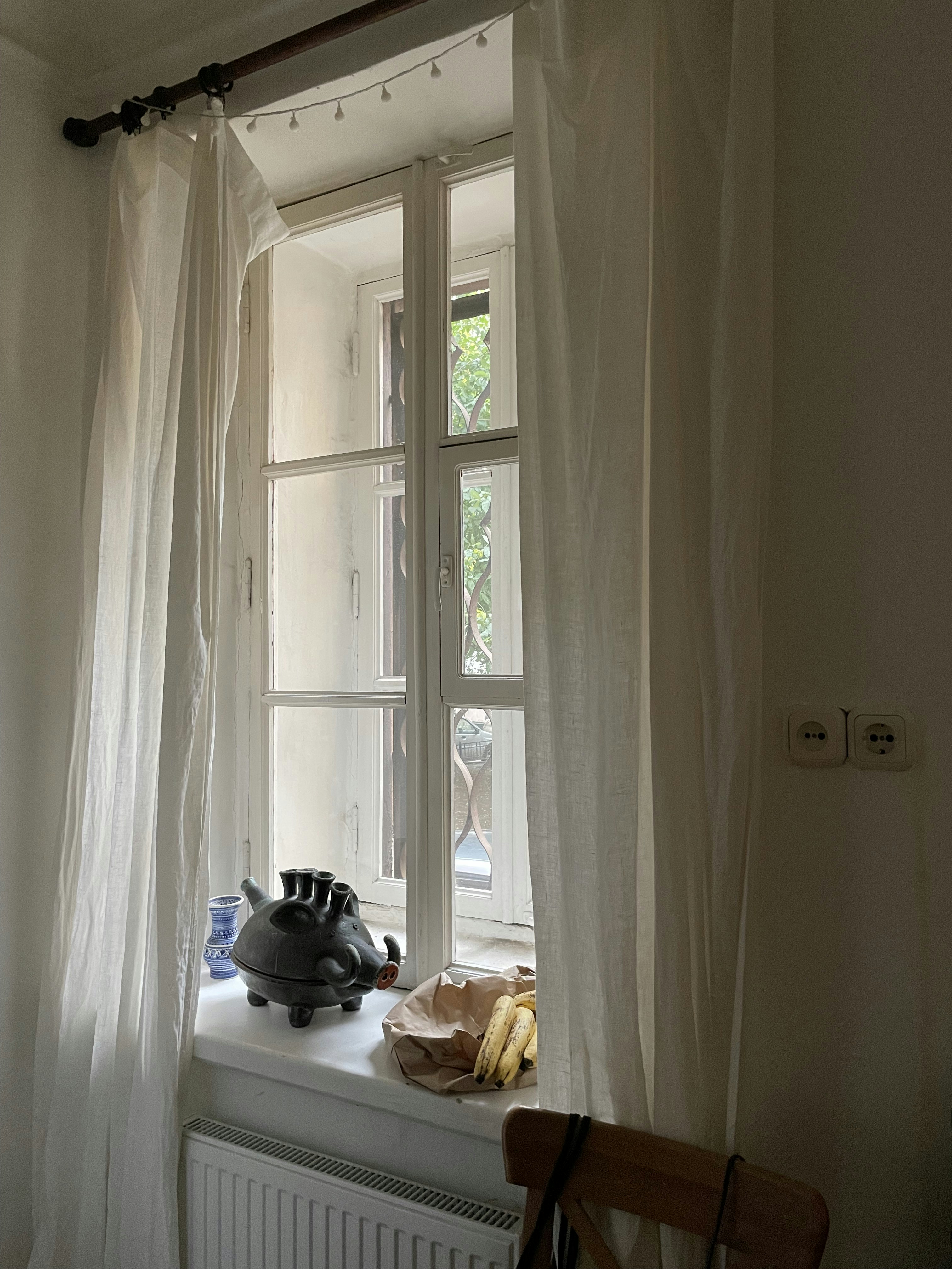 a window with a tea kettle on it
