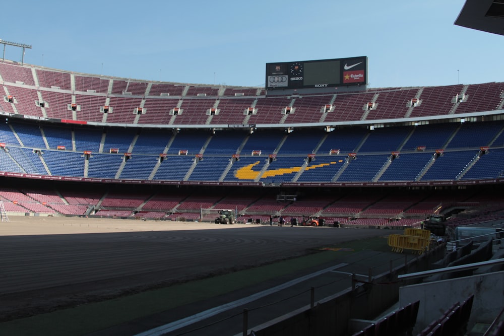 a sports stadium with a large screen with Camp Nou in the background