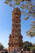 a tall tower with people around it