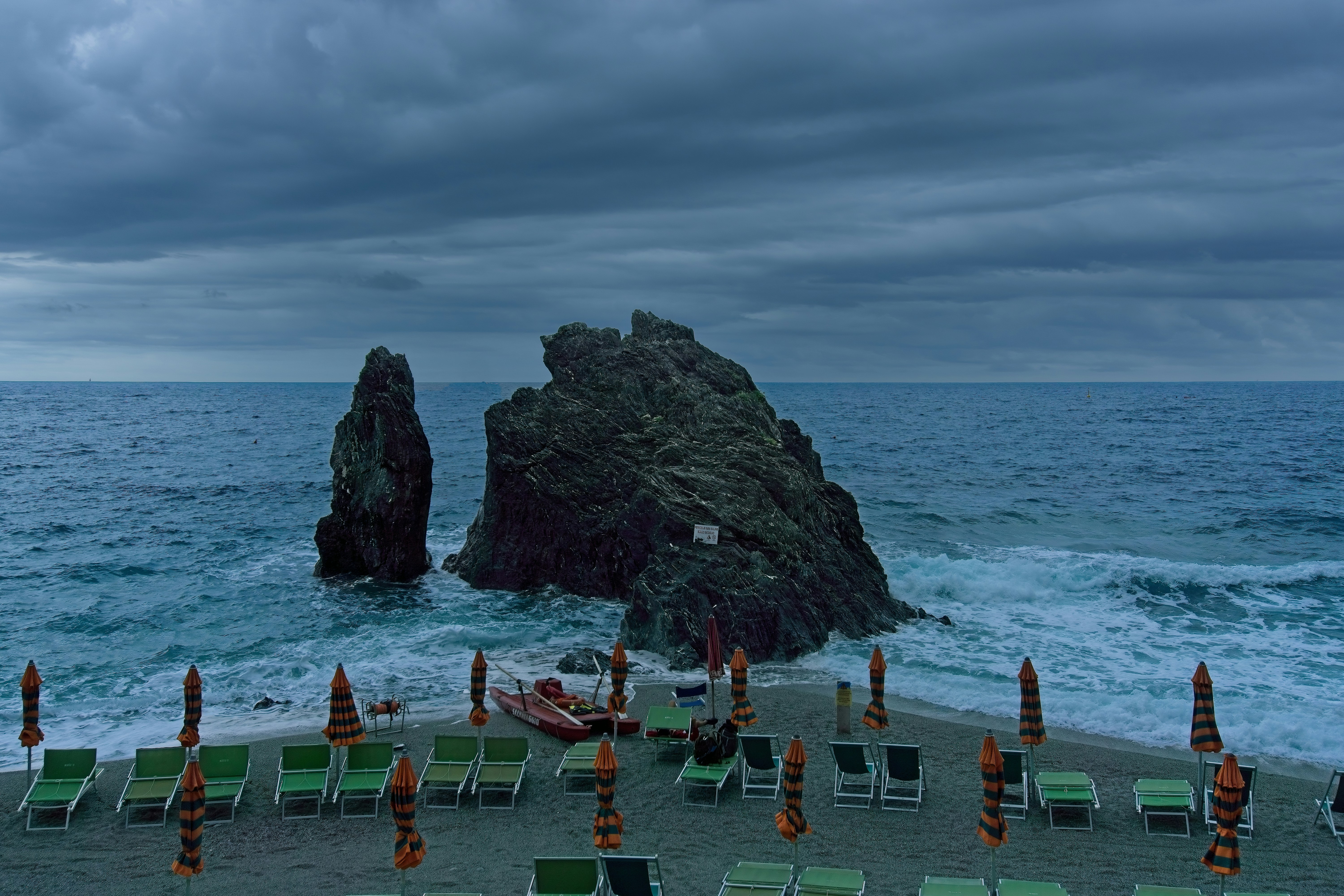 a beach with chairs and umbrellas