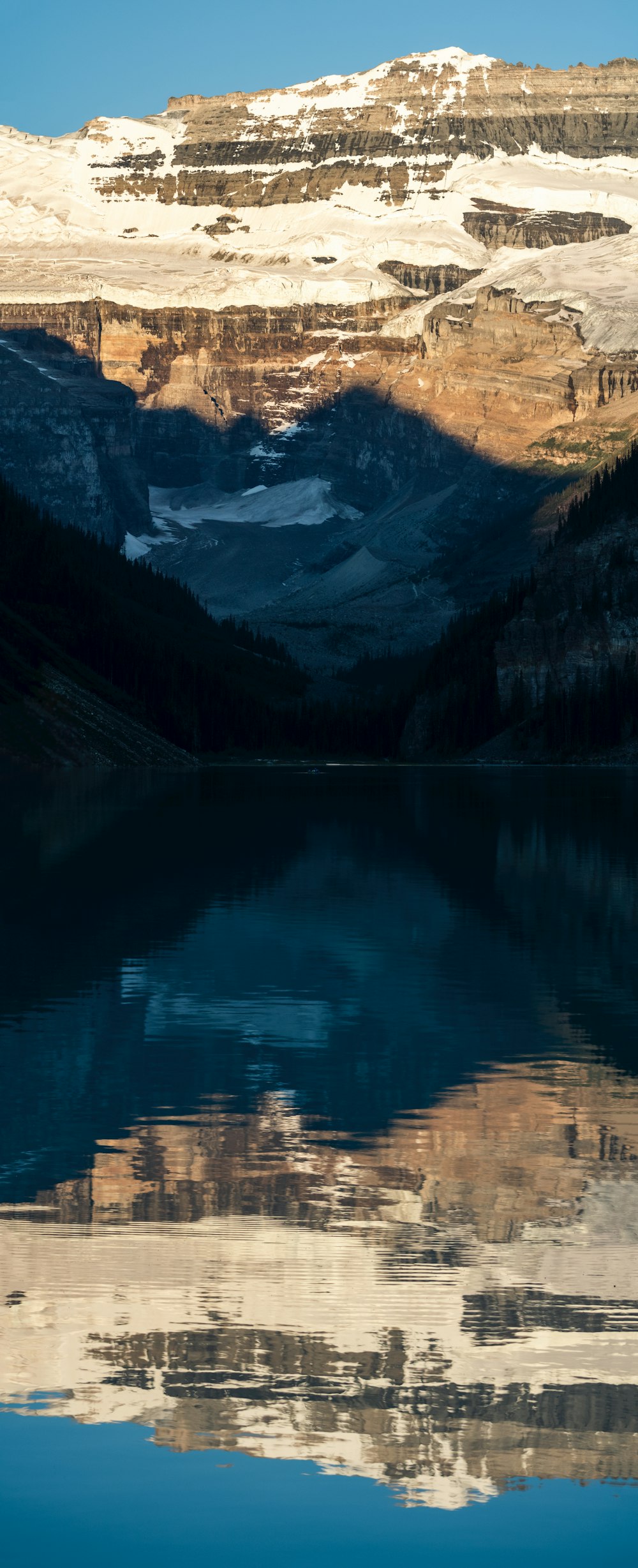 a body of water with mountains in the background