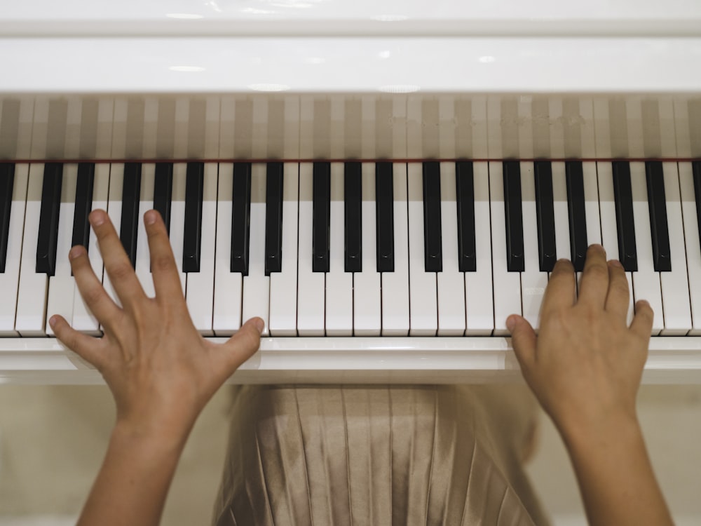 a person's hands on a piano keyboard