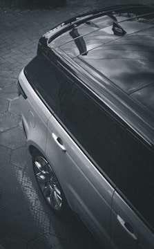 a black car parked on a brick road