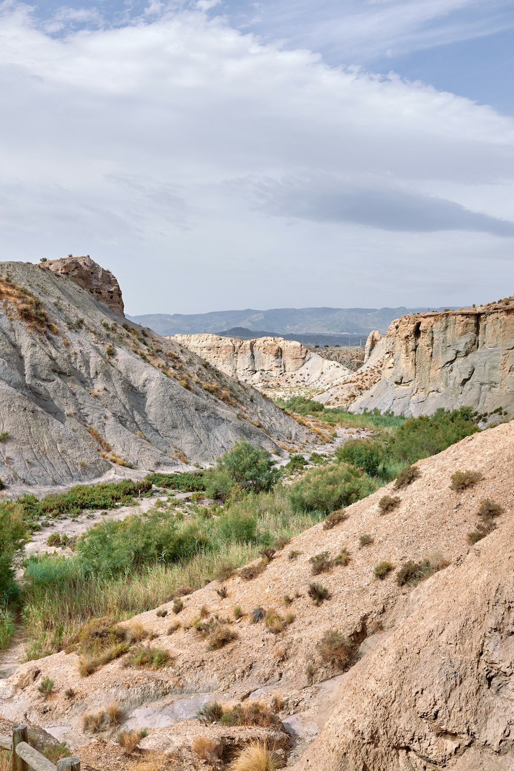 a rocky canyon with a valley below