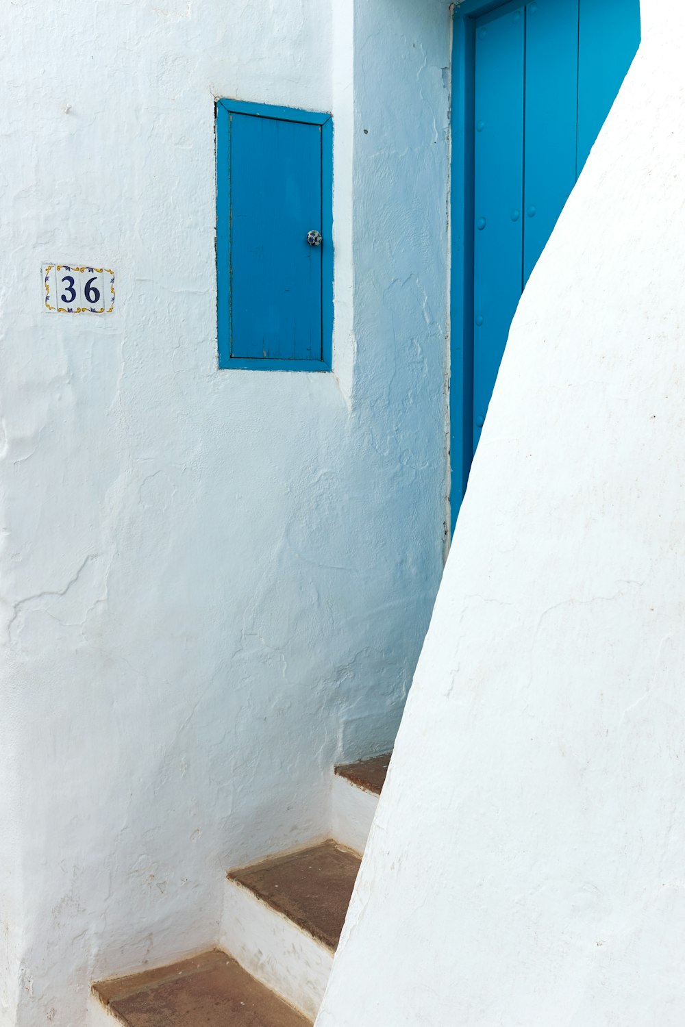 a blue door on a white wall