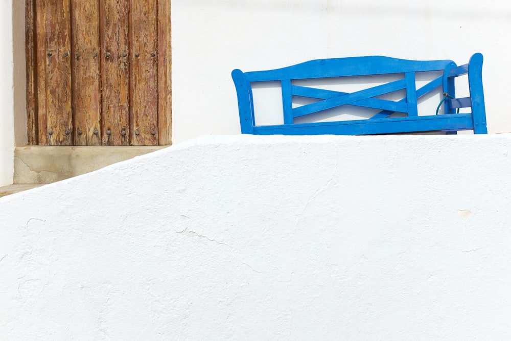 a blue bench in the snow