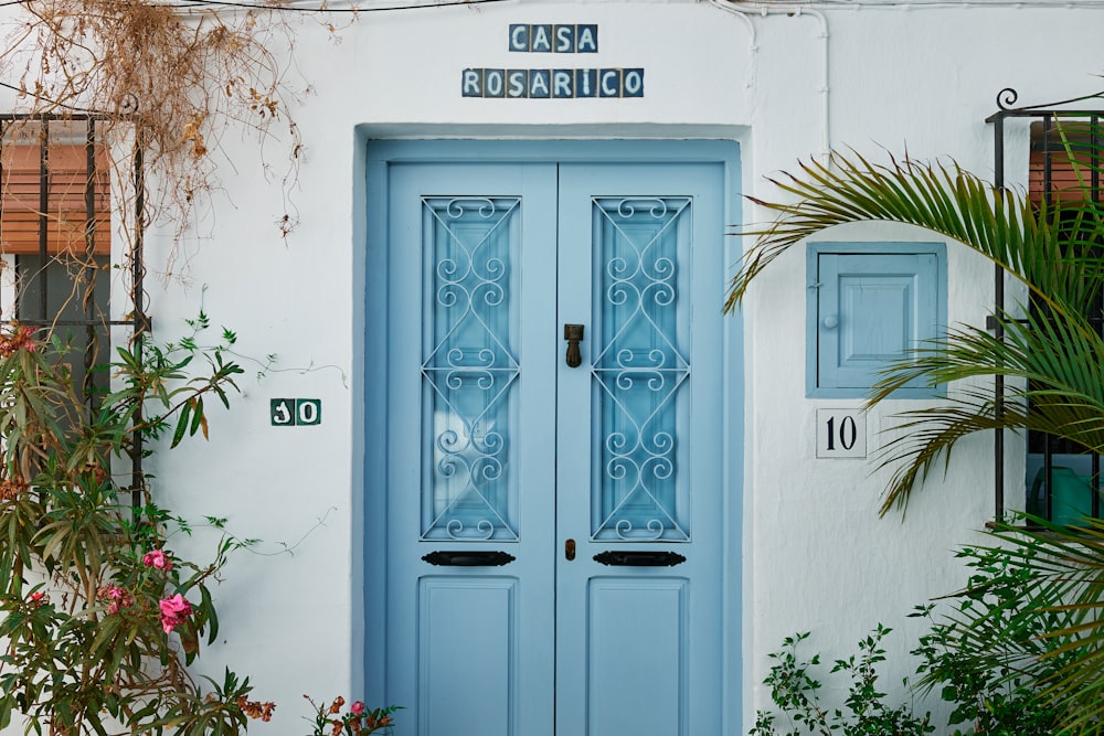 a blue door with a white building in the background