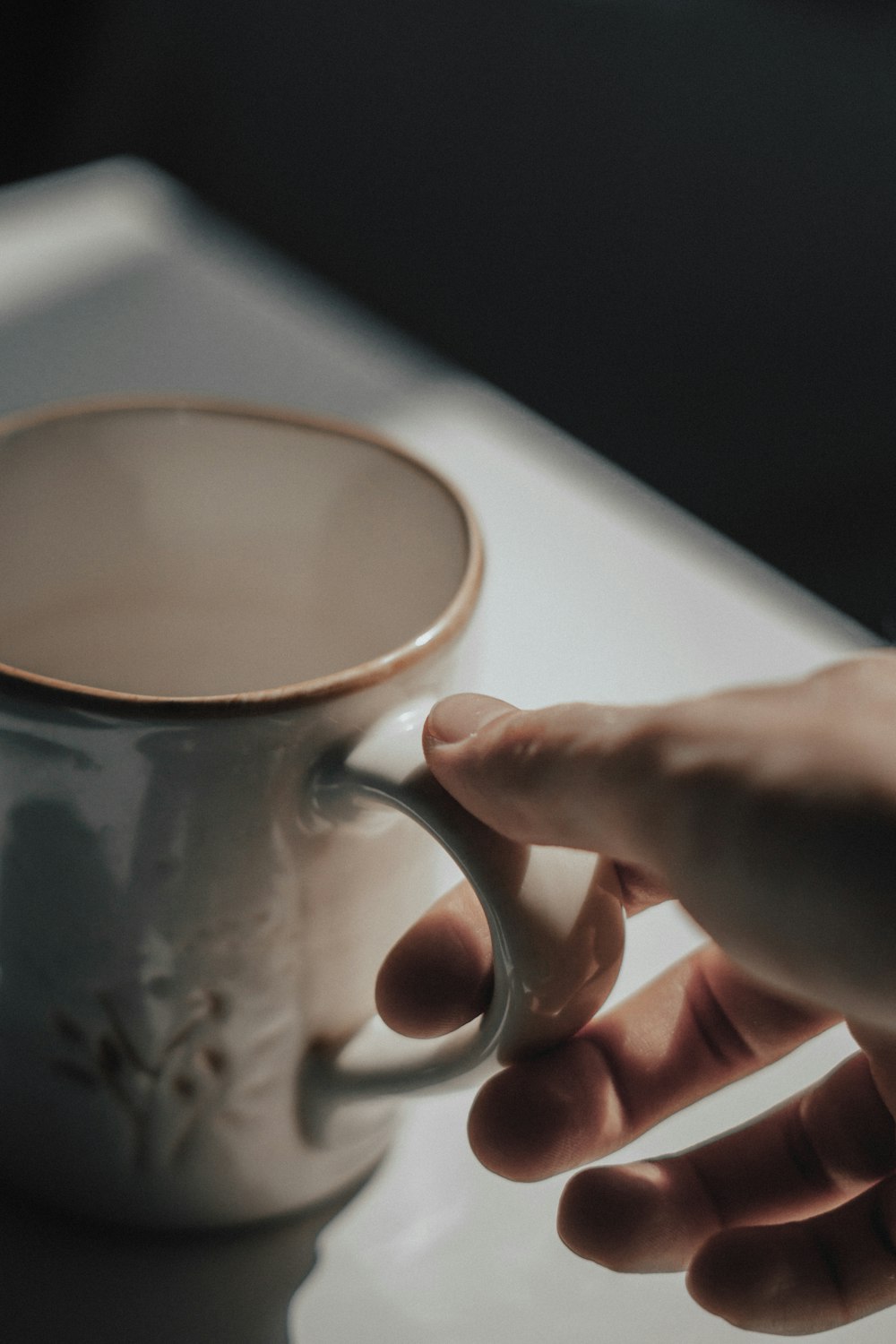 a person holding a coffee cup