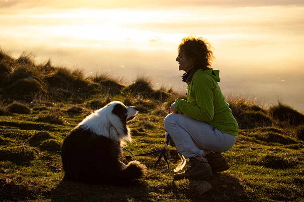 a person and a dog on a leash on a hill