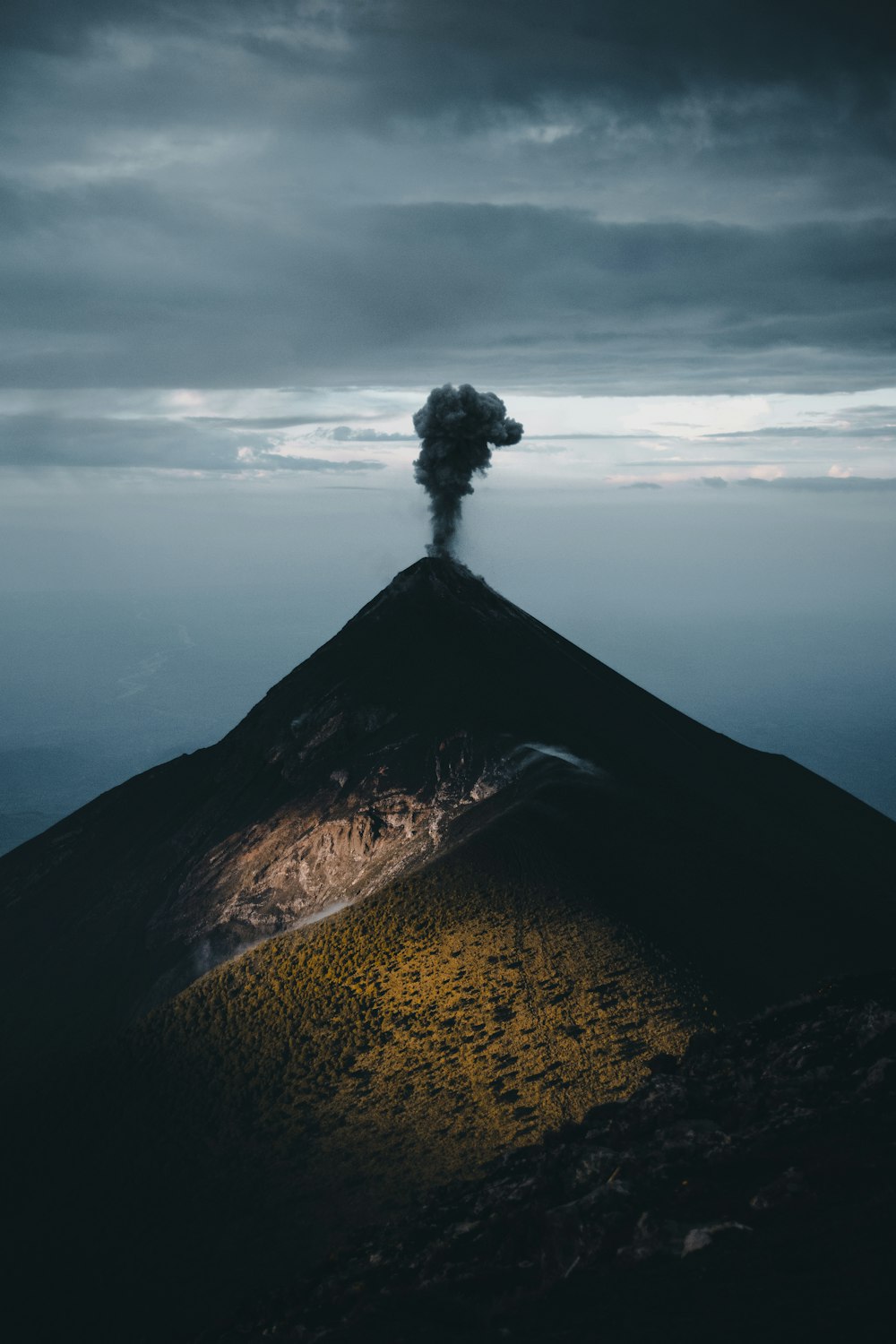 a mountain with a tree on top