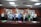 A group of professionals in a meeting room, smiling and discussing.