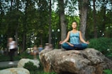 A serene image of a woman meditating in a park.