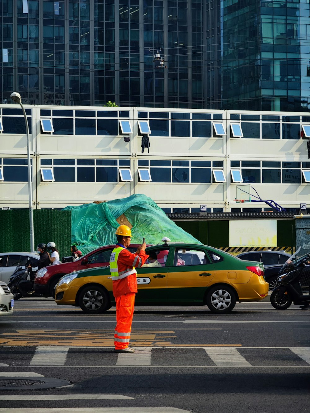 a person in an orange suit standing in front of a building